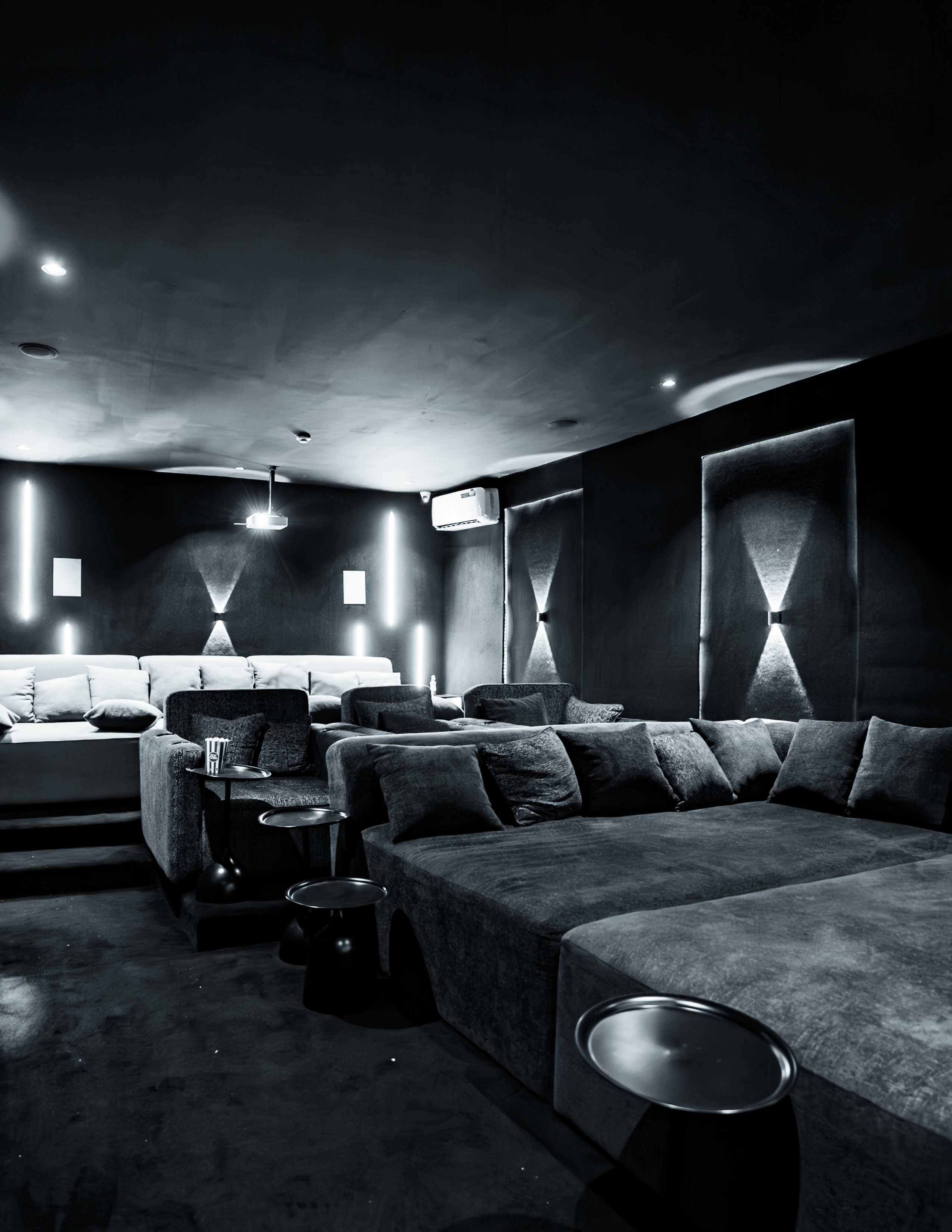 Tufted lounge seating with the screen glowing in the dark