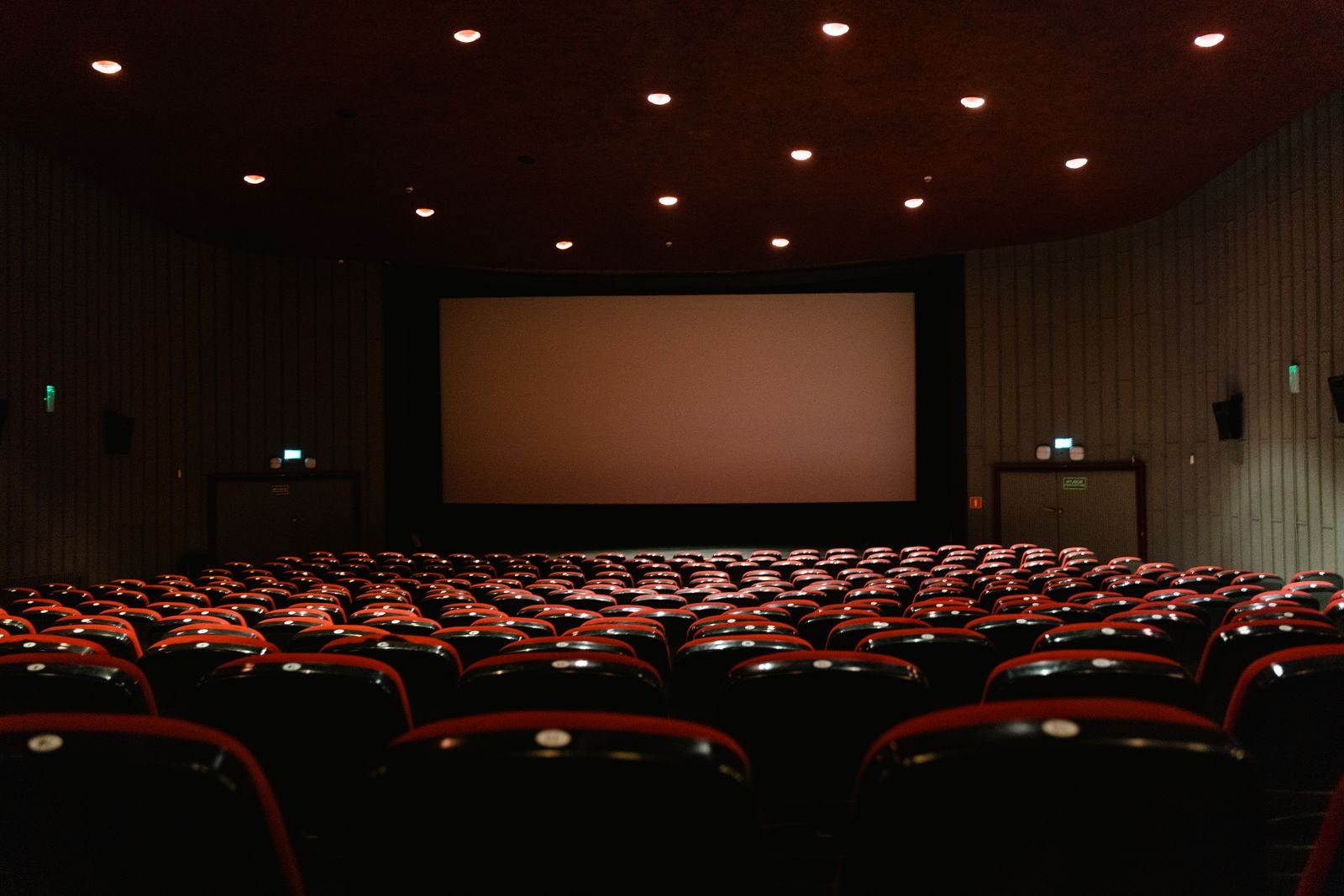 Empty cinema hall with the screen glowing in the dark