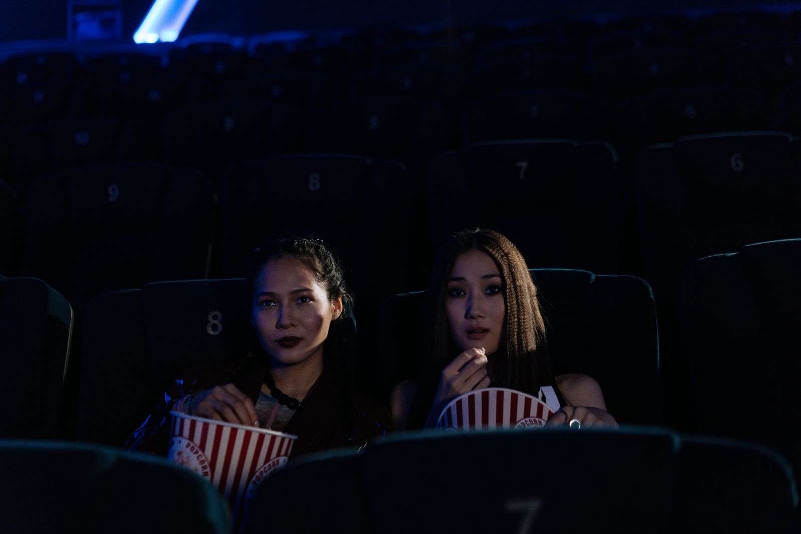 Friends sharing popcorn at the movies